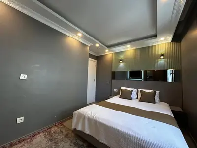 a bedroom with a large bed in a room at Sahrakent Otel Ataşehir in Istanbul