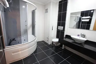 a bathroom with a tub and a toilet and a sink at Shilla Hotel in Velimeşe