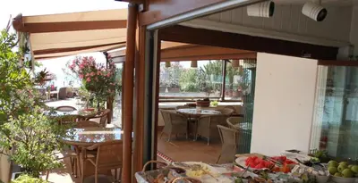 a patio with tables and chairs and a dining area at Hotel Sari Konak in Istanbul