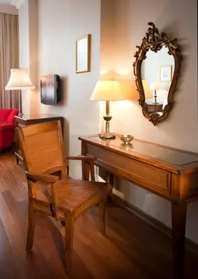 a room with a desk with a chair and a mirror at Hotel Sari Konak in Istanbul
