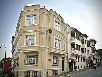 a tall yellow building on the side of a street at Hotel Sari Konak in Istanbul