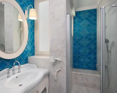 a bathroom with a sink and a shower at Hotel Sari Konak in Istanbul