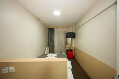 a hotel room with a bed and a television at Hotel Melita in Istanbul