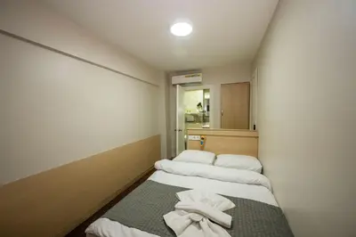 a small room with two beds with towels on them at Hotel Melita in Istanbul