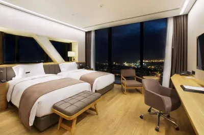a bedroom with a large bed and a desk with a desk at DoubleTree by Hilton Istanbul-Avcilar in Istanbul
