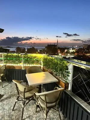 a table and chairs on a balcony with a view at Bade Boutique Hotel Kadıköy in Istanbul