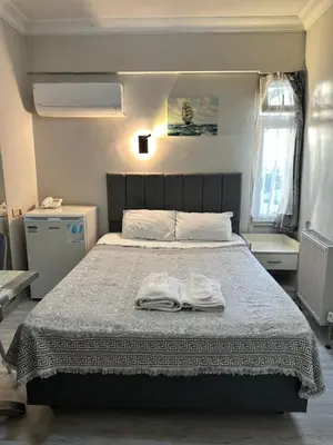 a bedroom with a bed with two white towels on it at Bade Boutique Hotel Kadıköy in Istanbul