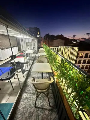 a balcony with tables and chairs on a building at Bade Boutique Hotel Kadıköy in Istanbul