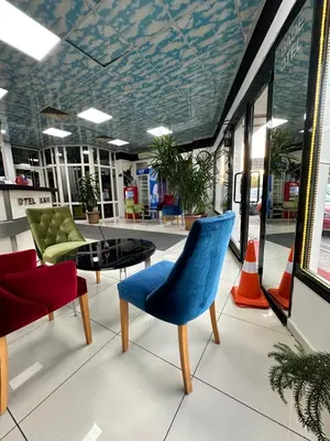 a lobby with a blue chair and a table at Bade Boutique Hotel Kadıköy in Istanbul