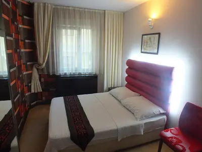a small bedroom with a bed and a window at Hotel Timya in Istanbul