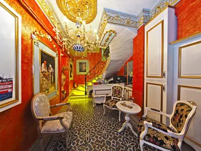 a room with red walls and a chandelier at Glamour Classic Hotel Istanbul Sirkeci in Istanbul