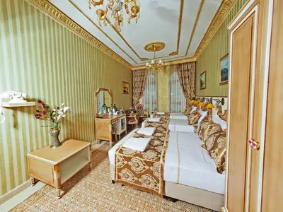 a bedroom with a bed and a vanity and a mirror at Glamour Classic Hotel Istanbul Sirkeci in Istanbul