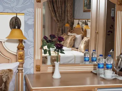 a bedroom with a bed and a table with water bottles at Glamour Classic Hotel Istanbul Sirkeci in Istanbul