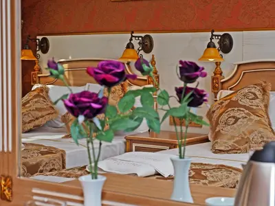 two vases with flowers in them on a bed at Glamour Classic Hotel Istanbul Sirkeci in Istanbul
