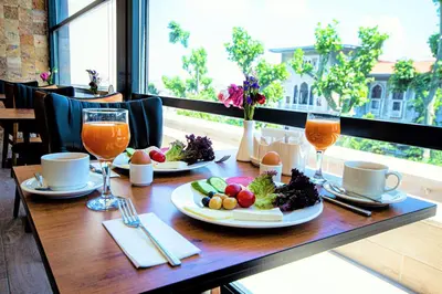 a table with plates of food and glasses of orange juice at Boss Hotel Sultanahmet in Istanbul