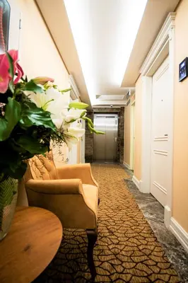a hallway with a couch and a table and flowers at Boss Hotel Sultanahmet in Istanbul
