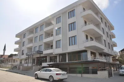 a white car parked in front of a building at Longoz Hotel in Igneada