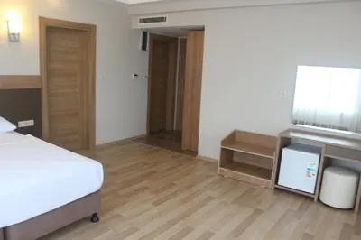 a hotel room with a bed and a television at Longoz Hotel in Igneada