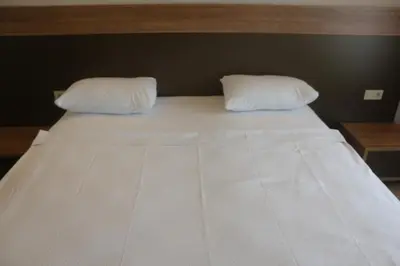 a large white bed with two pillows on it at Longoz Hotel in Igneada