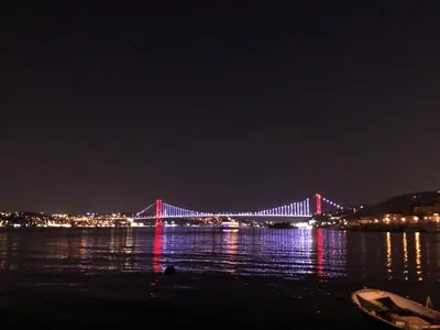 a bridge lit up in red and blue at night at Nomade Hotel Exclusive in Istanbul