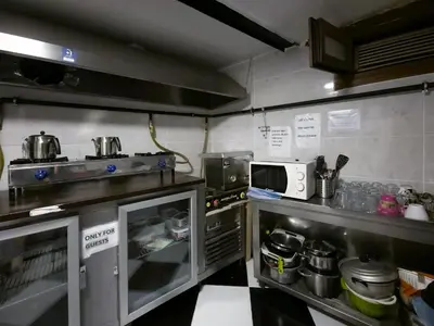 a kitchen with a stove and some pots and pans at Taksim Hostel Green House Istanbul in Istanbul