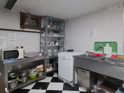 a kitchen with a sink and a counter with a microwave at Taksim Hostel Green House Istanbul in Istanbul