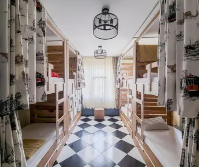 a room with bunk beds and a checkered floor at Taksim Hostel Green House Istanbul in Istanbul