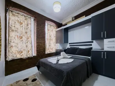 a bedroom with a bed with towels on it at Taksim Hostel Green House Istanbul in Istanbul
