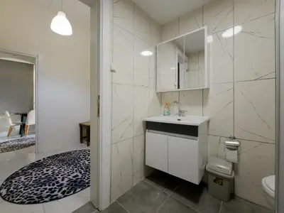 a white bathroom with a sink and a toilet at Taksim Hostel Green House Istanbul in Istanbul