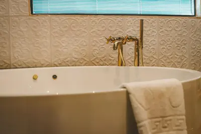 a bathroom with a bath tub with a towel at Mirart Hotel Boutique & SPA Yalova in Yalova