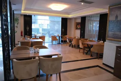 a restaurant with tables and chairs and a large window at Asia City Hotel Istanbul in Istanbul