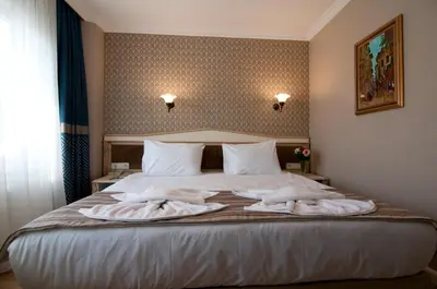 a bedroom with a bed with two towels on it at Mevlana Hotel in Istanbul
