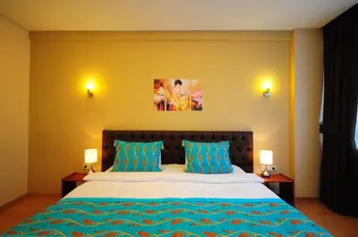 a bedroom with a bed with two blue pillows at Retropera Hotel in Istanbul