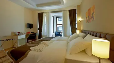a bedroom with a large bed with white pillows at Retropera Hotel in Istanbul