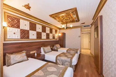 a hotel room with two beds and a ceiling at VERSİON HOTEL in Istanbul