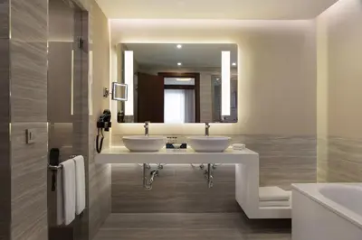 a bathroom with two sinks and a large mirror at Sheraton Istanbul City Center in Istanbul