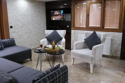 a living room with a couch and chairs and a table at Florya House Hotel in Istanbul