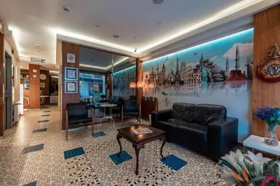 a lobby with a leather couch and a table at Elanaz Hotel in Istanbul