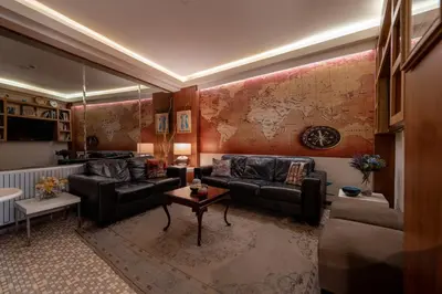 a living room with couches and a map on the wall at Elanaz Hotel in Istanbul