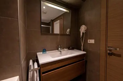 a bathroom with a sink and a phone on the wall at Elanaz Hotel in Istanbul