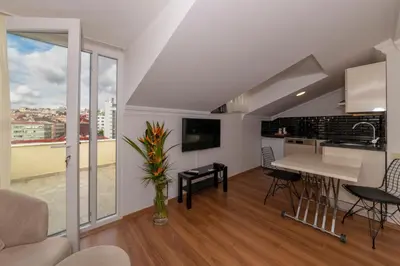 a kitchen and living room with a table and chairs at Joy Suites in Istanbul
