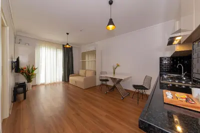 a kitchen and living room with a table and a couch at Joy Suites in Istanbul