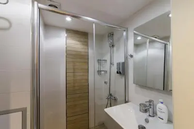 a bathroom with a shower with a sink and a mirror at Aston Hotel Taksim in Istanbul