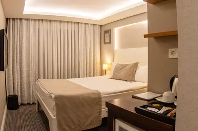 a hotel room with a bed and a desk at Aston Hotel Taksim in Istanbul