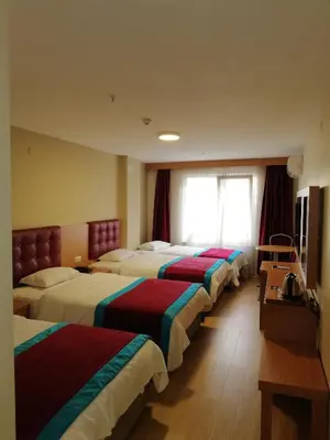 a row of beds in a hotel room at BURSA ŞAHiN HOTEL in Bursa