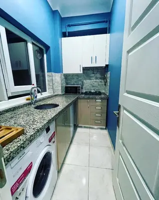 a small kitchen with a washing machine in it at donat suites apartment in Istanbul