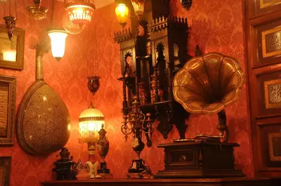 a room with a wall filled with lots of clocks and lights at Kybele Hotel in Istanbul
