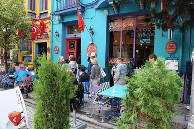 a group of people standing outside of a blue building at Kybele Hotel in Istanbul