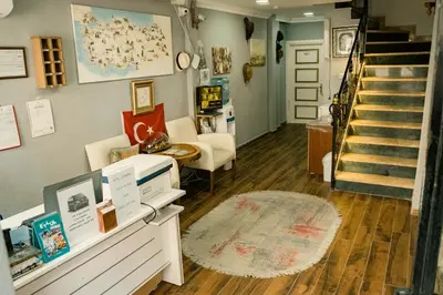 a living room with a staircase and a rug at Hotel Estambul in Istanbul