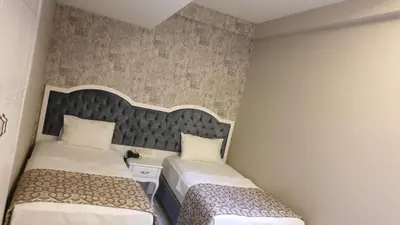 a small room with two beds and a headboard at The Meretto Hotel Istanbul Old City in Istanbul